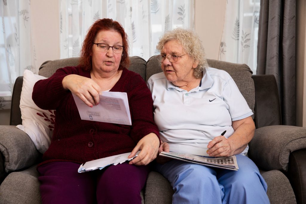 This is an image of two people reading a document.