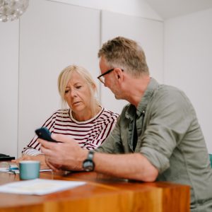 This is an image of two people looking at a phone.