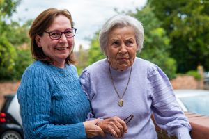 This is an image of an older woman on the right and a woman on the left.