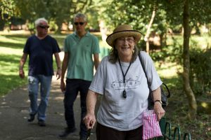 This is an image of a three people walking on a path.