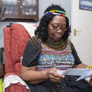 This is an image of a woman reading a document.