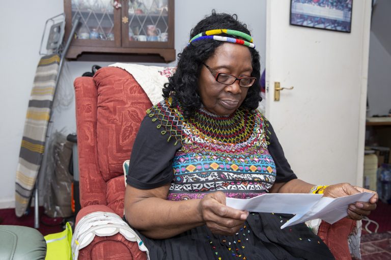 This is an image of a woman reading a document.
