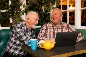 This is an image of two men looking at a computer.