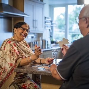 This is an image of a female and male carer playing a puzzle.