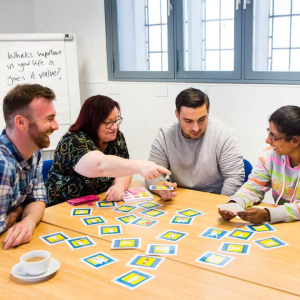 This is an image of four people round a table organising cards.